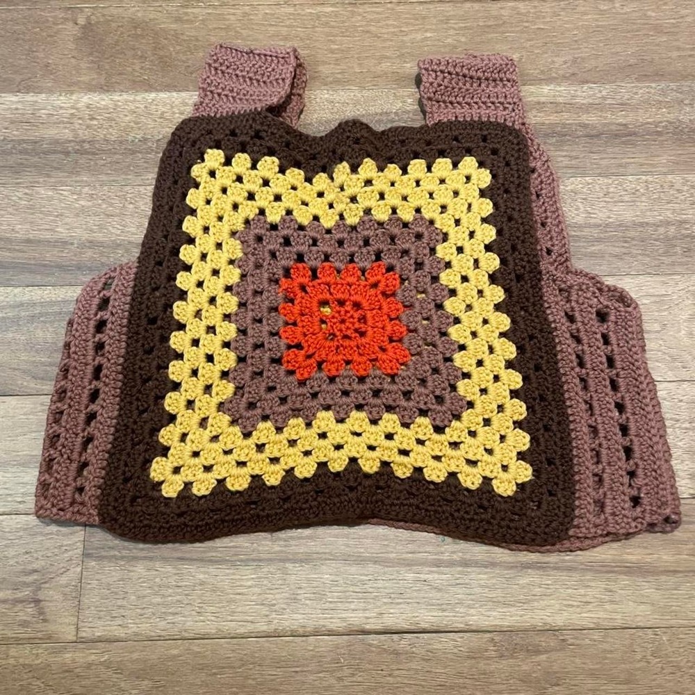 Handmade crochet vest with brown, yellow, and orange granny square design